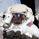 NASA astronaut Andrew Morgan prepares to take a photograph while conducting a spacewalk outside the International Space Station Nov. 22, 2019.